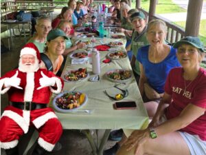 Photo of Santa joining the group for the potluck picnic at the Hocking Hills celebration in July 2025